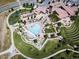 Aerial view of the community clubhouse and pool with lounge areas and manicured landscaping at 15194 W Washburn Ave, Lakewood, CO 80228