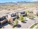 Aerial view showcasing a neighborhood, nearby mountains, and construction in the distance at 15194 W Washburn Ave, Lakewood, CO 80228