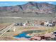 An aerial view of the community with a pond and mountain views at 15194 W Washburn Ave, Lakewood, CO 80228