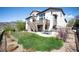 Spacious backyard with lush grass, a stone patio, hot tub, and mature landscaping, perfect for outdoor living at 15194 W Washburn Ave, Lakewood, CO 80228