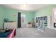 Light and airy bedroom boasting mint-painted walls, plush carpeting, and a large window for ample natural light at 15194 W Washburn Ave, Lakewood, CO 80228