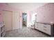 Charming bedroom with carpet, star decals, and a view of the attached bathroom through an open doorway at 15194 W Washburn Ave, Lakewood, CO 80228