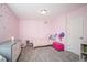 Cozy bedroom featuring pink walls, soft gray carpeting and a cute accent wall with gold star embellishments at 15194 W Washburn Ave, Lakewood, CO 80228