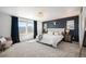 Inviting bedroom features plush carpeting, large windows, and a stylish accent wall at 15194 W Washburn Ave, Lakewood, CO 80228
