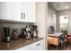 Close up of the sleek counter with coffee and espresso makers near a bright office space at 15194 W Washburn Ave, Lakewood, CO 80228
