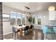 Bright dining room with modern chandelier, large windows, and scenic mountain view at 15194 W Washburn Ave, Lakewood, CO 80228
