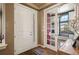Inviting foyer with wood floors, a stylish door, and a view into a bright room at 15194 W Washburn Ave, Lakewood, CO 80228