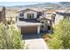 A well-maintained front exterior with stone accents, 2 car garage and landscaping at 15194 W Washburn Ave, Lakewood, CO 80228