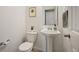 Clean and modern half bath with a pedestal sink and neutral decor at 15194 W Washburn Ave, Lakewood, CO 80228