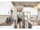 Modern kitchen boasts white cabinets, stainless steel appliances, and tiled backsplash at 15194 W Washburn Ave, Lakewood, CO 80228