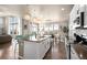 Bright kitchen boasts a large island, pendant lighting, stainless appliances, and an eat-in area with natural light at 15194 W Washburn Ave, Lakewood, CO 80228