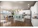 Spacious open kitchen features island seating, pendant lighting, and stainless steel appliances at 15194 W Washburn Ave, Lakewood, CO 80228