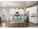 Modern kitchen features stainless steel appliances, a center island, and stylish pendant lighting at 15194 W Washburn Ave, Lakewood, CO 80228