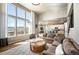 Spacious living room boasts large windows, hardwood floors, and comfortable seating at 15194 W Washburn Ave, Lakewood, CO 80228