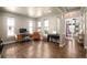 Open living room with hardwood floors, desk and music area, plus great natural lighting at 15194 W Washburn Ave, Lakewood, CO 80228