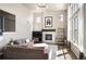 Bright living room features a fireplace, large windows, and comfortable seating area at 15194 W Washburn Ave, Lakewood, CO 80228