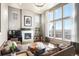 Bright living room with large windows, fireplace, and comfortable seating area at 15194 W Washburn Ave, Lakewood, CO 80228