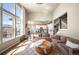 Spacious living room featuring tall windows, an open floor plan, and modern decor at 15194 W Washburn Ave, Lakewood, CO 80228