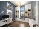 A home office with built-in shelving, a large window, and modern decor at 15194 W Washburn Ave, Lakewood, CO 80228