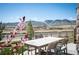 Enjoy al fresco dining with mountain views on the outdoor patio featuring a dining table and chairs at 15194 W Washburn Ave, Lakewood, CO 80228