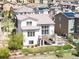 Back view of a two-story home with a deck, patio, landscaped backyard, and neighborhood views at 15194 W Washburn Ave, Lakewood, CO 80228