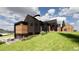 Modern home with wood and metal siding, large windows and hillside location at 11168 Wild Chase Pl, Franktown, CO 80116