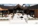 Outdoor kitchen, lounge area, and firepit create an inviting patio space at 11168 Wild Chase Pl, Franktown, CO 80116