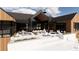 Spacious patio with an outdoor kitchen, seating area, and fire pit at 11168 Wild Chase Pl, Franktown, CO 80116