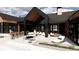 Large patio features an outdoor kitchen, seating area, and fire pit at 11168 Wild Chase Pl, Franktown, CO 80116