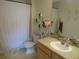 Neutral toned bathroom with a shower, toilet, vanity and decorative accents at 569 Alton Way # E, Denver, CO 80230