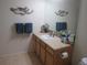 Bathroom featuring a spacious vanity with ample storage and a large mirror for convenience at 569 Alton Way # E, Denver, CO 80230
