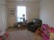 Well-lit bedroom with wood floors and a window, complemented by a reading chair at 569 Alton Way # E, Denver, CO 80230
