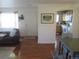 Open-concept living space with wood floors, seamlessly flowing into the dining area and kitchen at 569 Alton Way # E, Denver, CO 80230