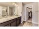 Bathroom with double vanity, a shower, and a view of a closet, offering style and functionality at 16057 E 47Th Pl, Denver, CO 80239