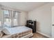 Neutral bedroom featuring a neatly made bed, soft natural light, and a practical storage unit at 16057 E 47Th Pl, Denver, CO 80239