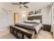 Cozy bedroom featuring a wooden bed frame with storage, complemented by soft neutral tones and natural light at 16057 E 47Th Pl, Denver, CO 80239