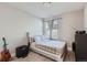 Cozy bedroom with a comfortable bed, soft lighting, and a guitar adding a personal touch at 16057 E 47Th Pl, Denver, CO 80239