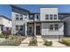 Stylish townhouse showcases modern design, landscaping, and inviting walkway to the front door at 16057 E 47Th Pl, Denver, CO 80239