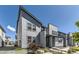 Contemporary two-story townhouse with clean lines, large windows, and professional landscaping at 16057 E 47Th Pl, Denver, CO 80239