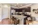 Open kitchen with granite countertops, stainless steel appliances, and eat-in island at 16057 E 47Th Pl, Denver, CO 80239