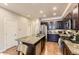 Modern kitchen featuring granite countertops, stainless steel appliances, and an island with seating at 16057 E 47Th Pl, Denver, CO 80239