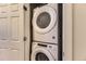 Convenient laundry area with a stacked washer and dryer, optimizing space and efficiency at 16057 E 47Th Pl, Denver, CO 80239