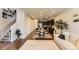 Open-concept living area with a dining space and kitchen, creating an airy, connected living space at 16057 E 47Th Pl, Denver, CO 80239