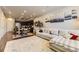 Open-concept living space with hardwood floors, modern kitchen, and comfortable seating area at 16057 E 47Th Pl, Denver, CO 80239
