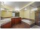 Bathroom showcasing a soaking tub, walk-in shower, and double sinks with granite countertops at 8100 E Union Ave # 614, Denver, CO 80237