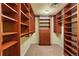 Walk-in closet featuring custom wood shelving and drawers for optimal storage at 8100 E Union Ave # 614, Denver, CO 80237