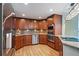 Kitchen with wood cabinets, countertops, stainless steel appliances, and wood flooring at 8100 E Union Ave # 614, Denver, CO 80237
