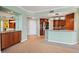 Modern kitchen features updated appliances, breakfast bar, and wooden cabinets at 8100 E Union Ave # 614, Denver, CO 80237