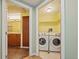 Convenient in-unit laundry area with a washer, dryer, and a view of bathroom at 8100 E Union Ave # 614, Denver, CO 80237