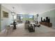 Spacious living room with large windows offering beautiful city views at 8100 E Union Ave # 614, Denver, CO 80237